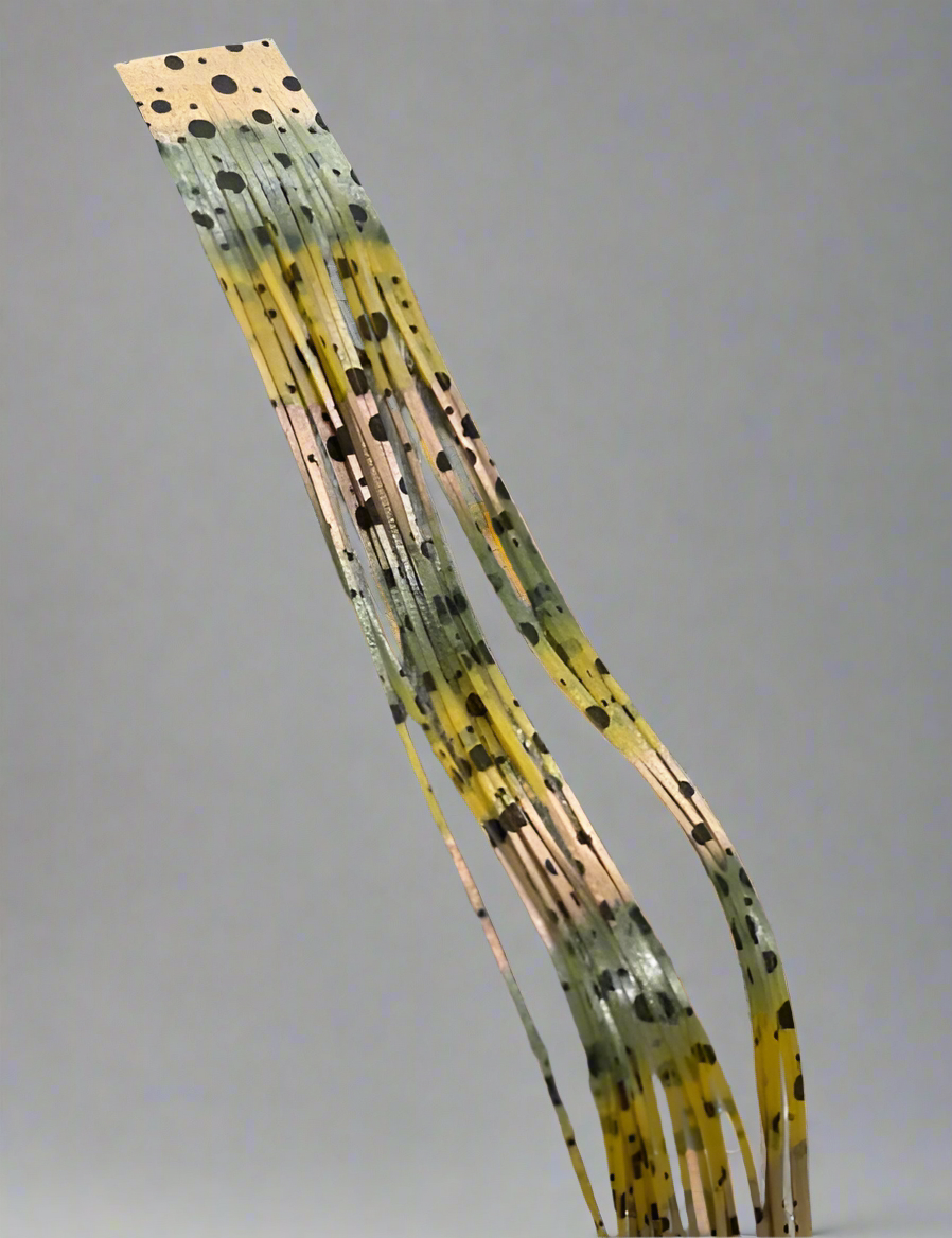 A steele with a mix of green, brown, and black colors, featuring a dotted pattern.