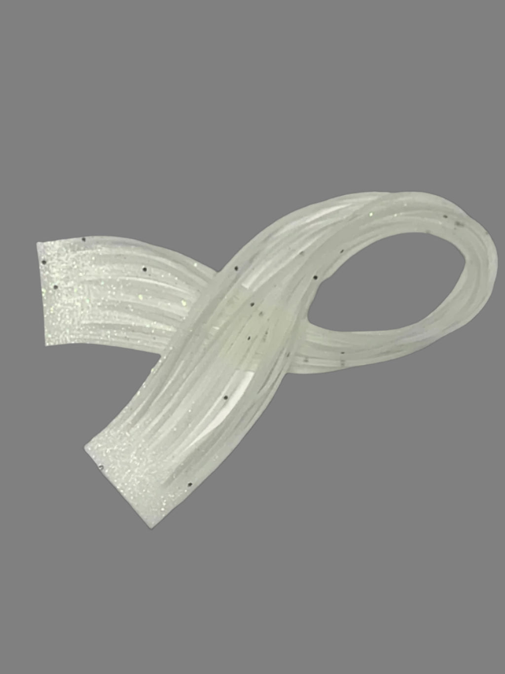 Glow silicone skirt tab 8801-288 with black flake and green glow layer shown in normal daylight.
