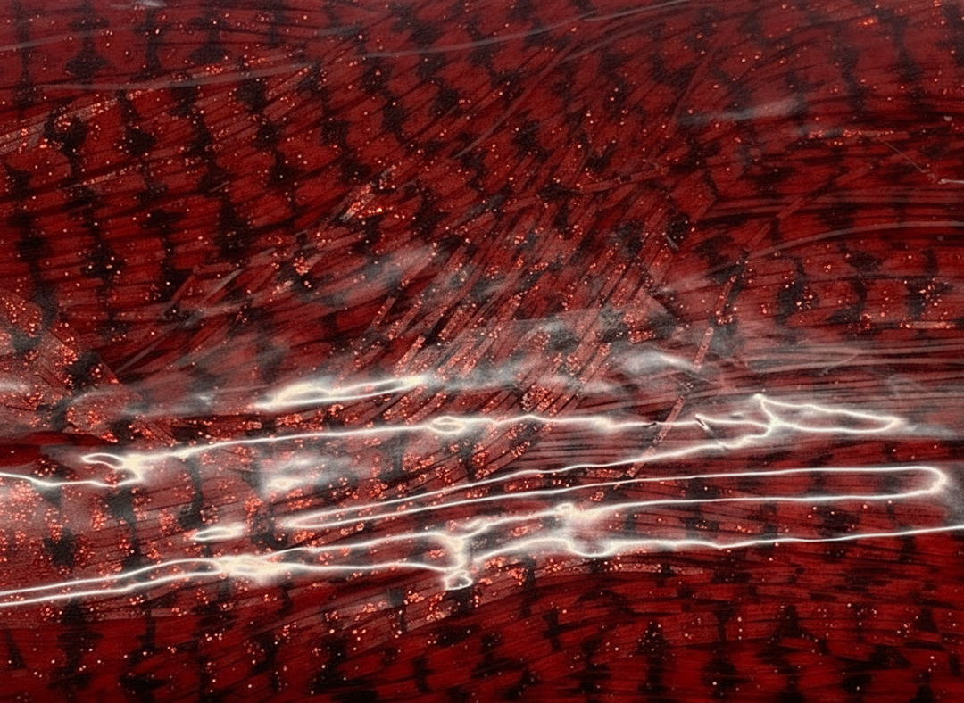 Close-up of 8806-673 Barbed Wire Red with Red Flake silicone jig skirt tabs showing metallic flake finish and rich crimson coloring